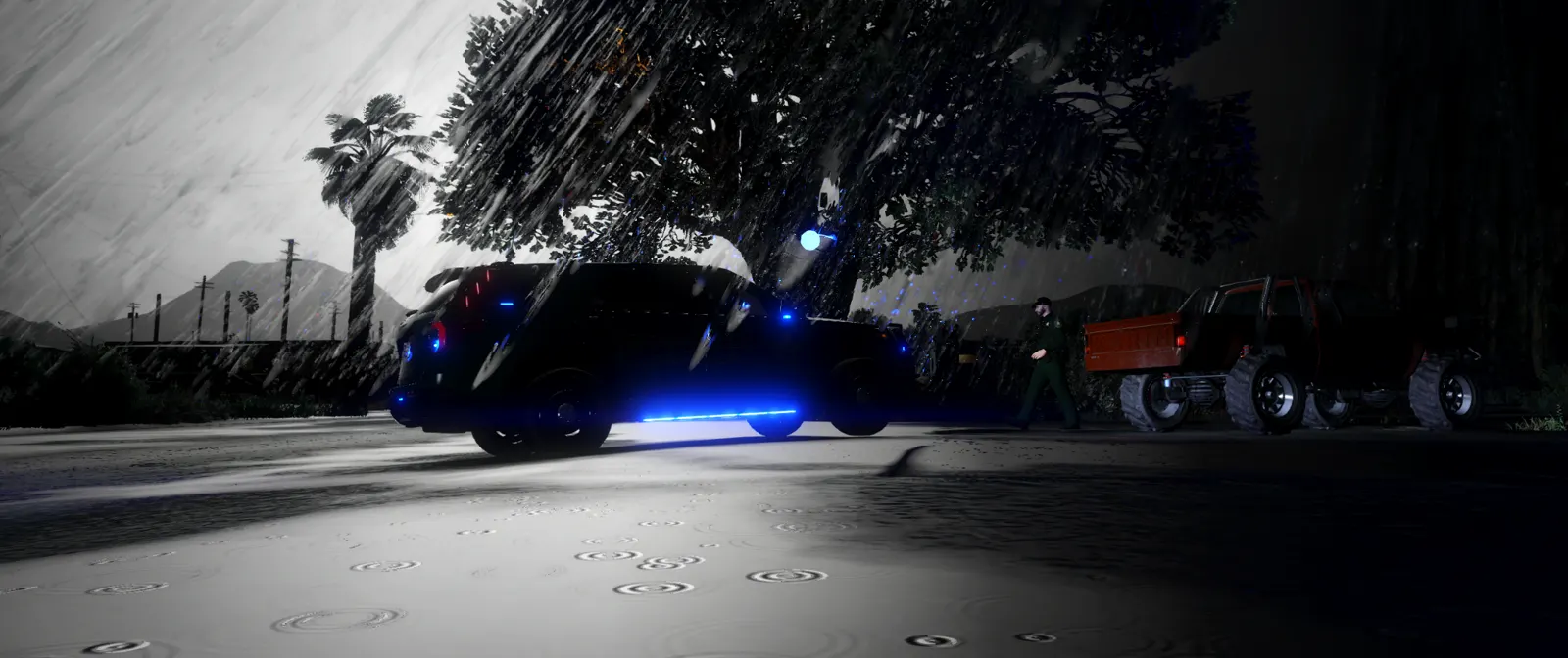 Deputy walking up to a truck in heavy rain with blue lights